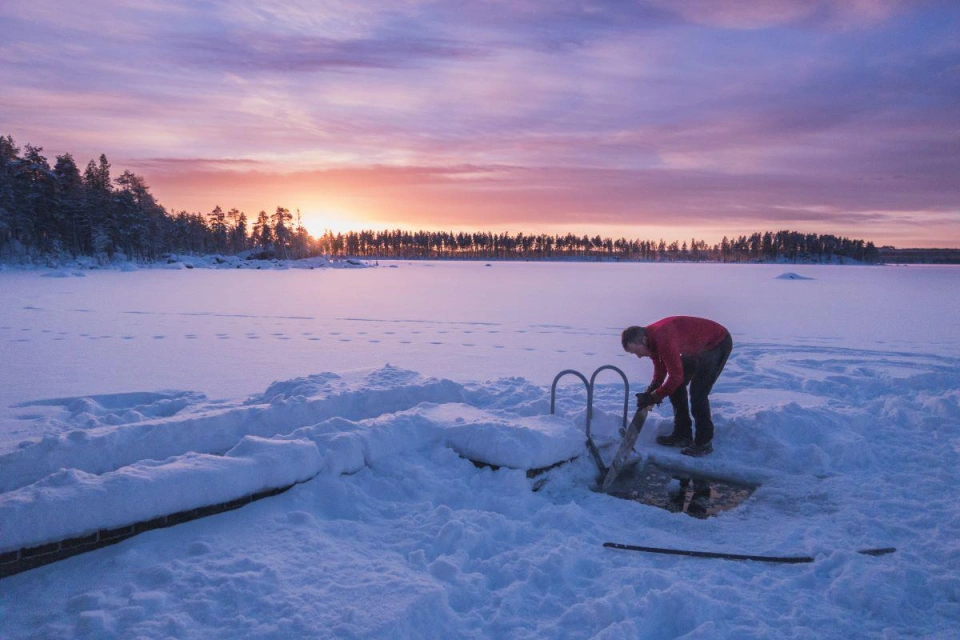 Man cutting ice bath lake Staggtrask by Tilde Bergstrom